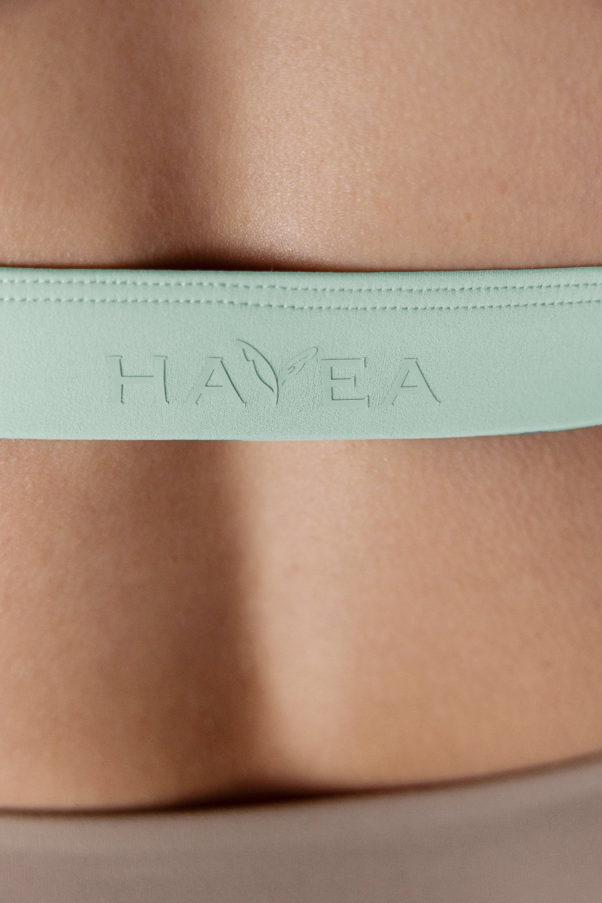 Havea Logo on back strap of light blue sports bra