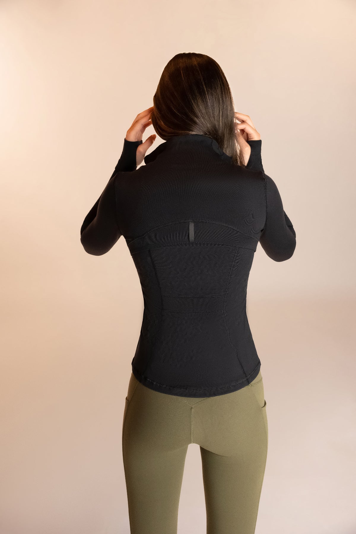 Womens ventilated running jacket in black form fitting 